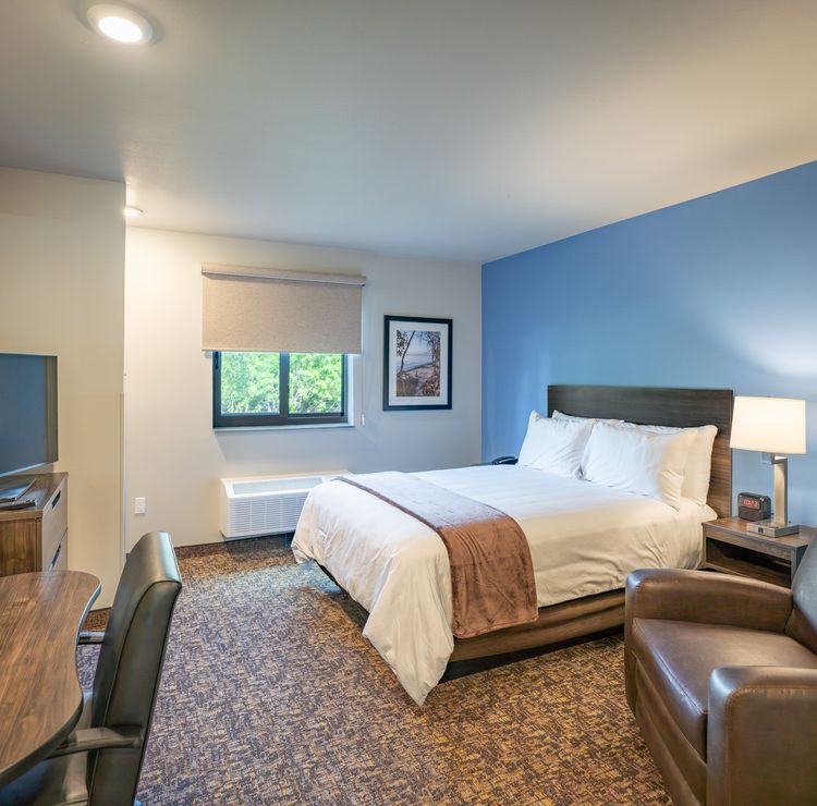 Port Charlotte hotel interior with one bed and one recliner