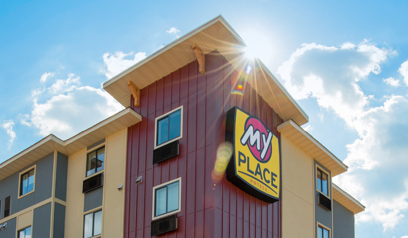 Exterior of top-half of My Place Hotel-Lithia Springs, GA with hotel logo.