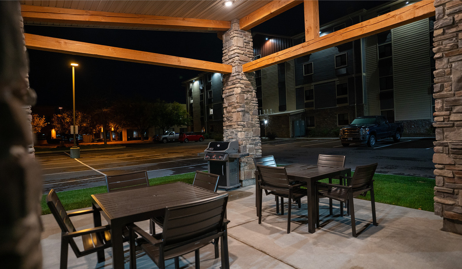 Exterior of My Place Hotel-Boise/Meridian, ID's grilling pavilion lit at night.