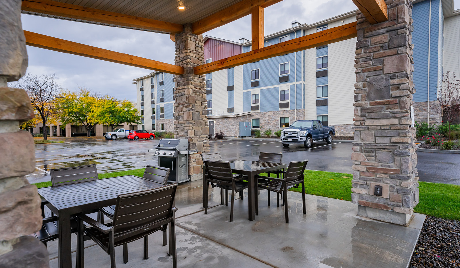 Exterior of My Place Hotel-Boise/Meridian, ID grilling pavilion with hotel in the background.