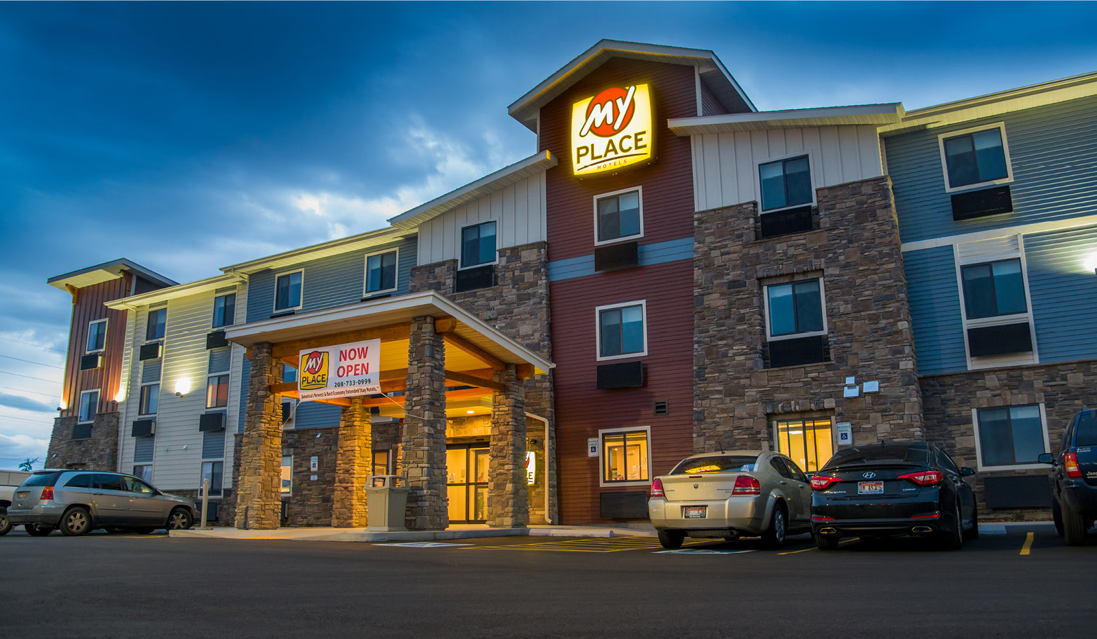 Exterior of My Place Hotel-Boise/Meridian, ID at sunset with lit entrance.