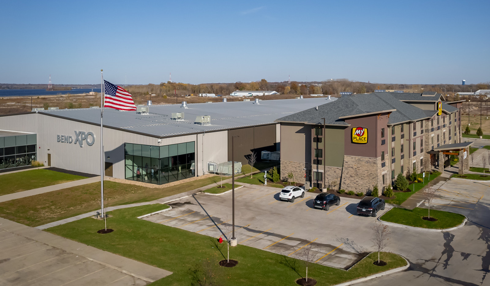 Drone-view exterior of My Place Hotel-East Moline, IL and its connection to Bend XPO building.