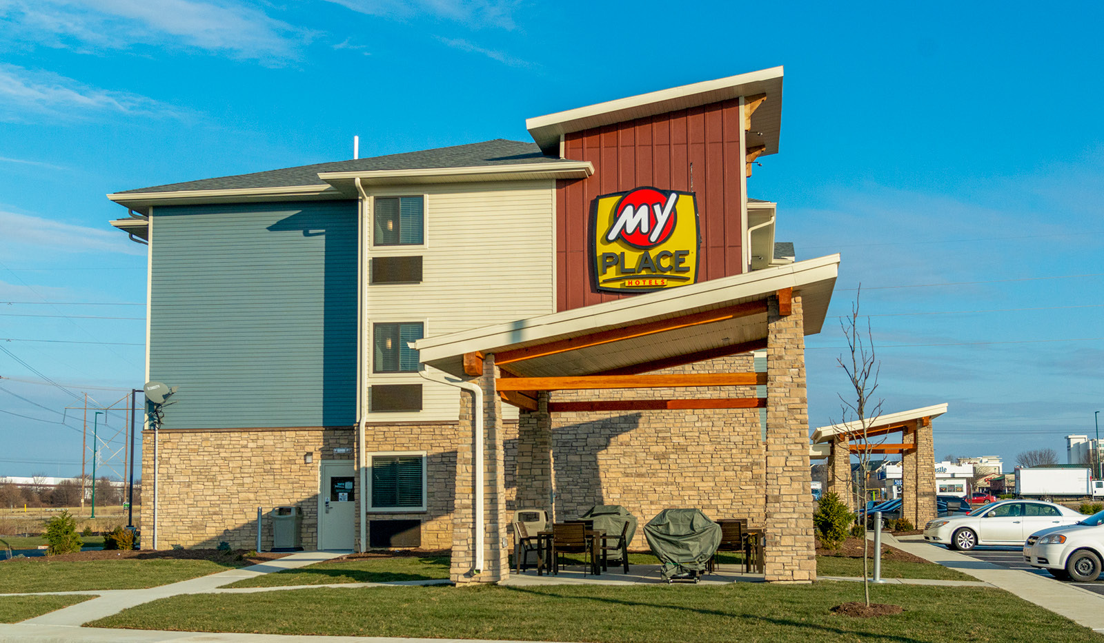 Exterior of My Place Hotel-Chicago/North Aurora, IL showing side and grilling pavilion.