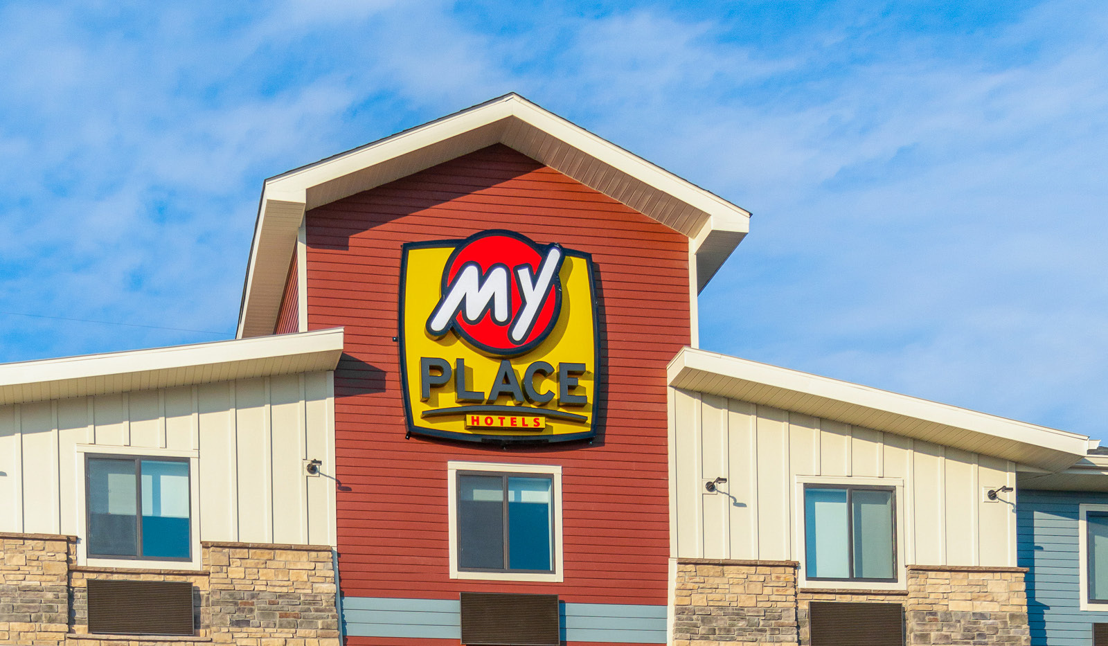 Top-half exterior of My Place Hotel-Chicago/North Aurora, IL focusing on sign and logo.