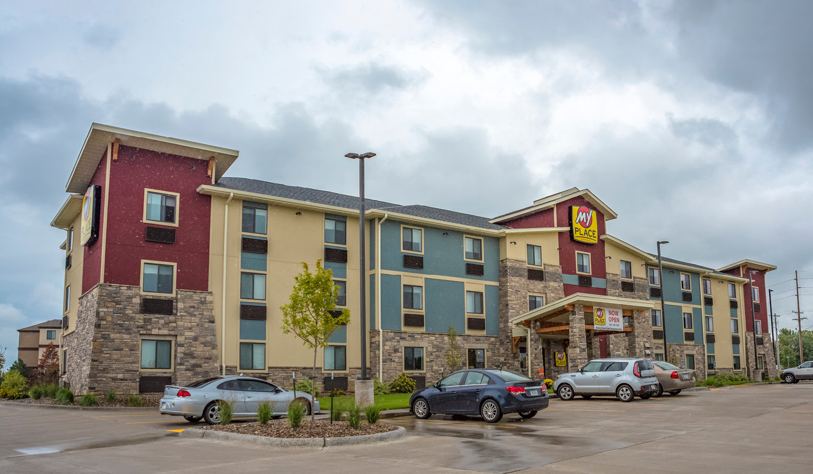 Exterior of My Place Hotel-Davenport, IA under a cloudy sky.