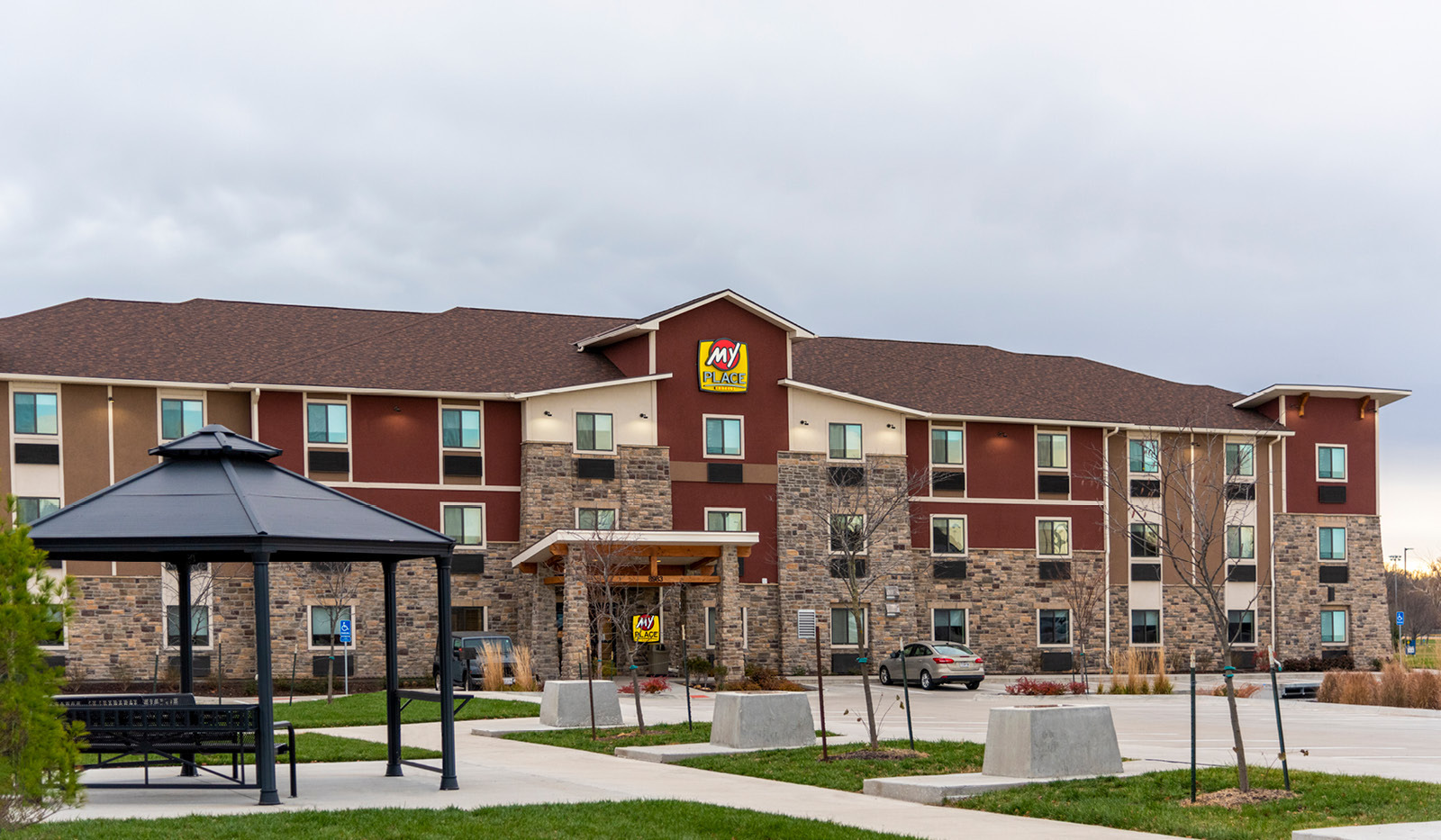 Exterior of My Place Hotel-Overland Park, KS with black pavilion in the foreground.