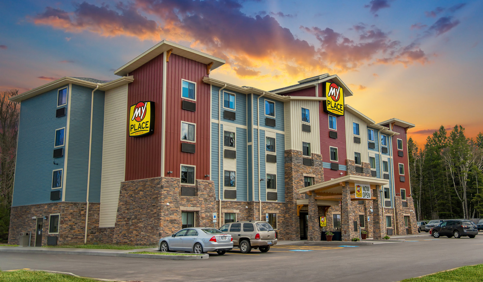 Exterior of My Place Hotel-Marquette, MI with under a colorful sunset.