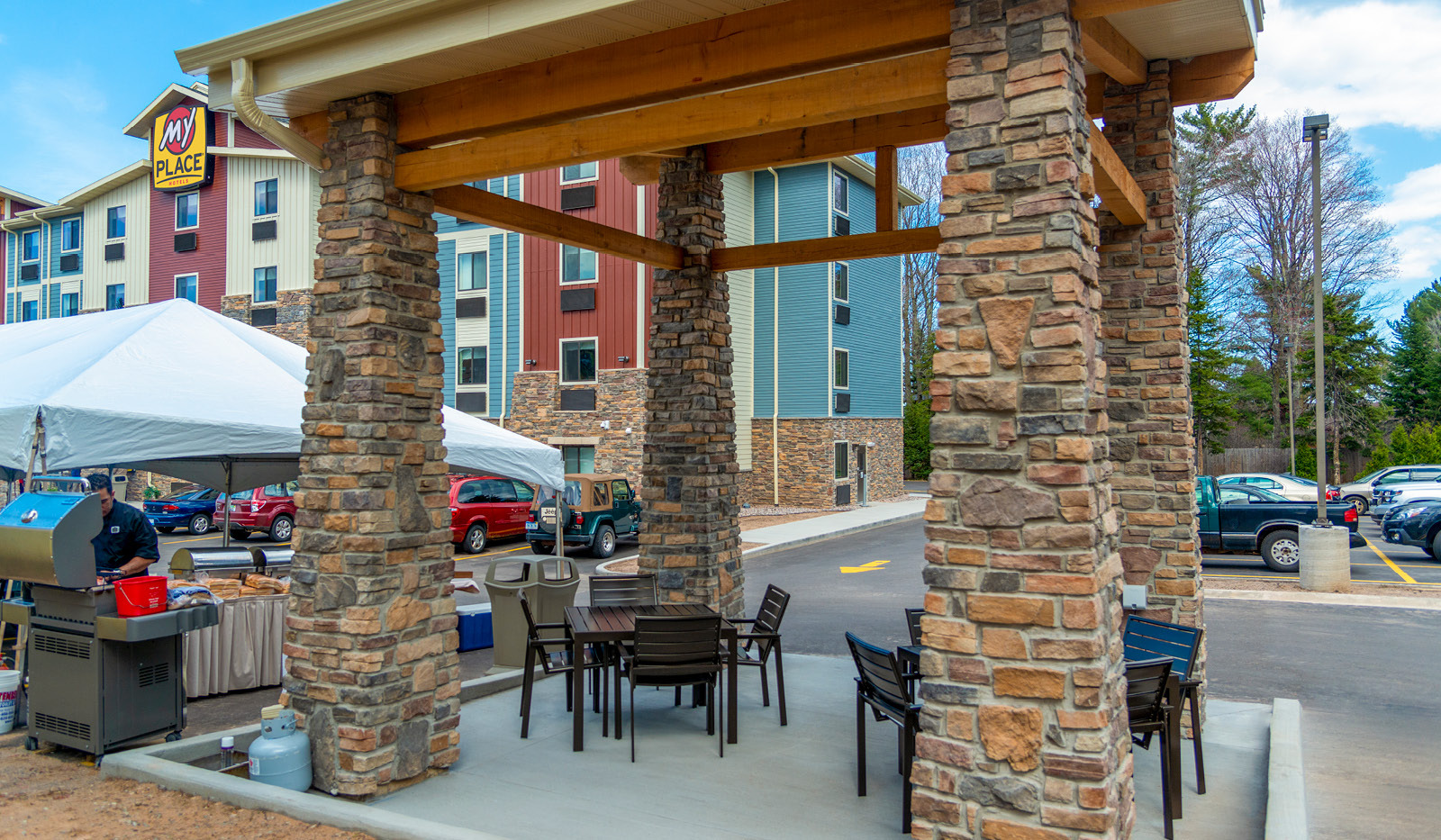 Exterior of My Place Hotel-Marquette, MI's grilling pavilion with hotel in the background.