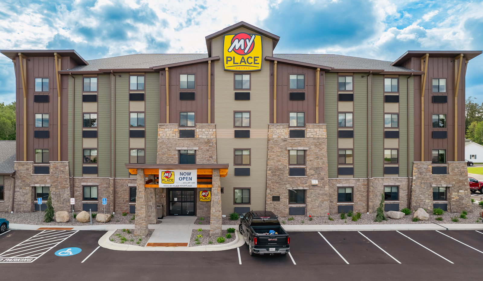 Front view of the property with the open now sight hung high on the entryway.