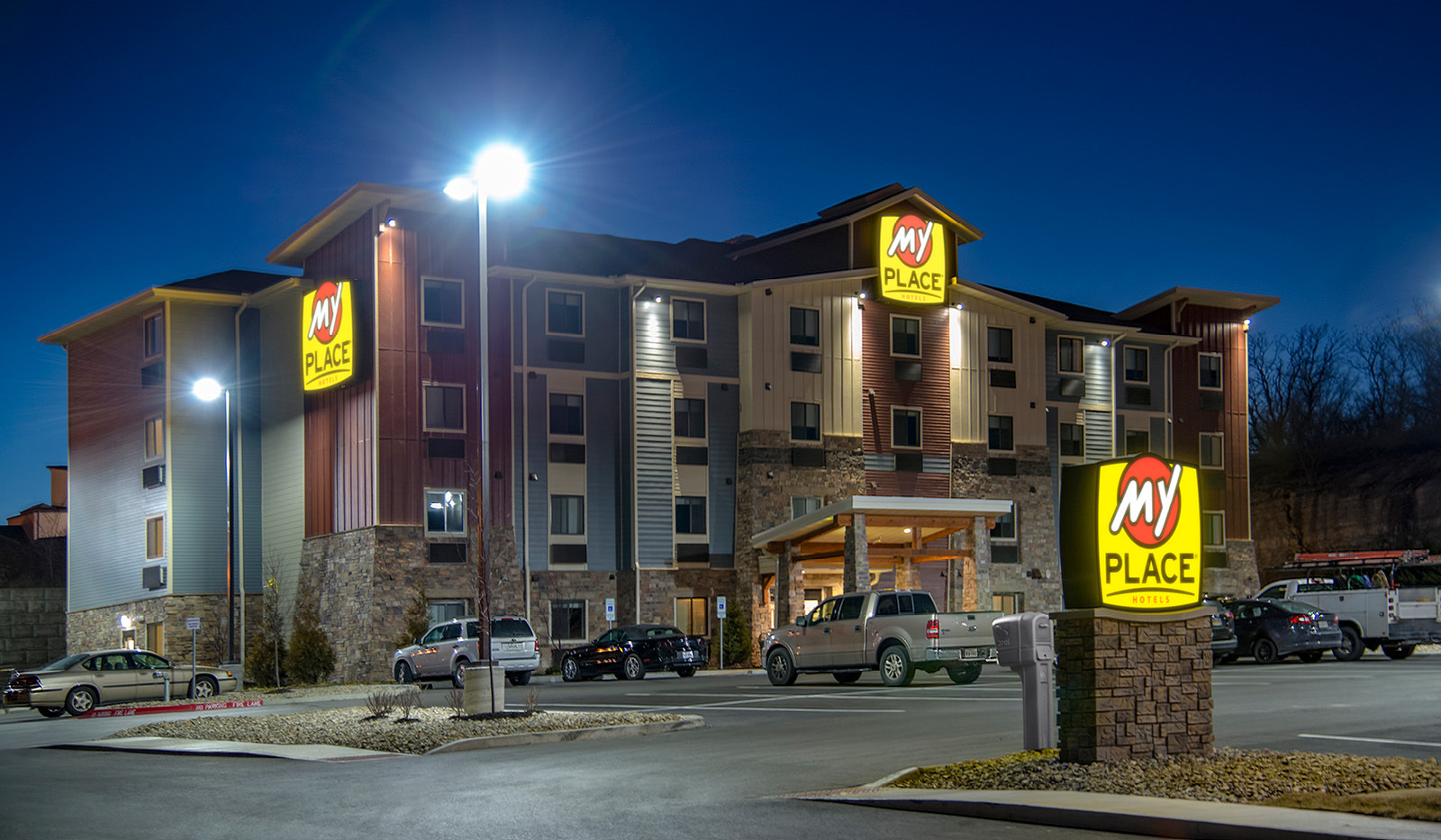 Exterior of My Place Hotel-Independence, MO illuminated at night.