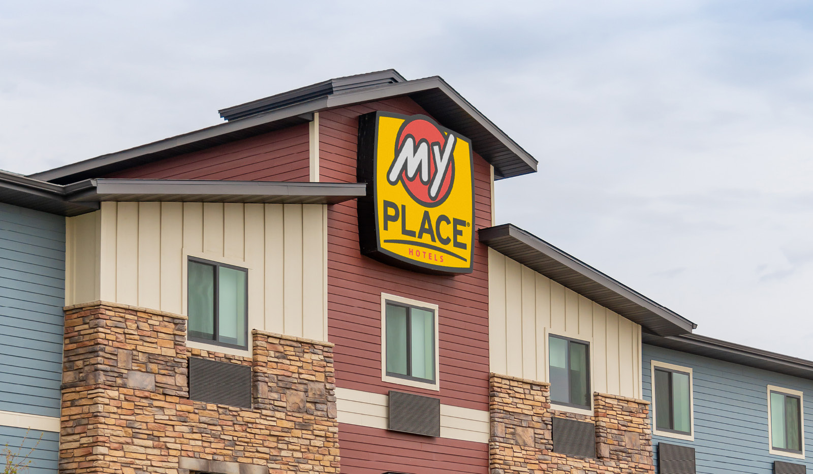 Top-half exterior of My Place Hotel-Billings, MT with focus on logo sign.