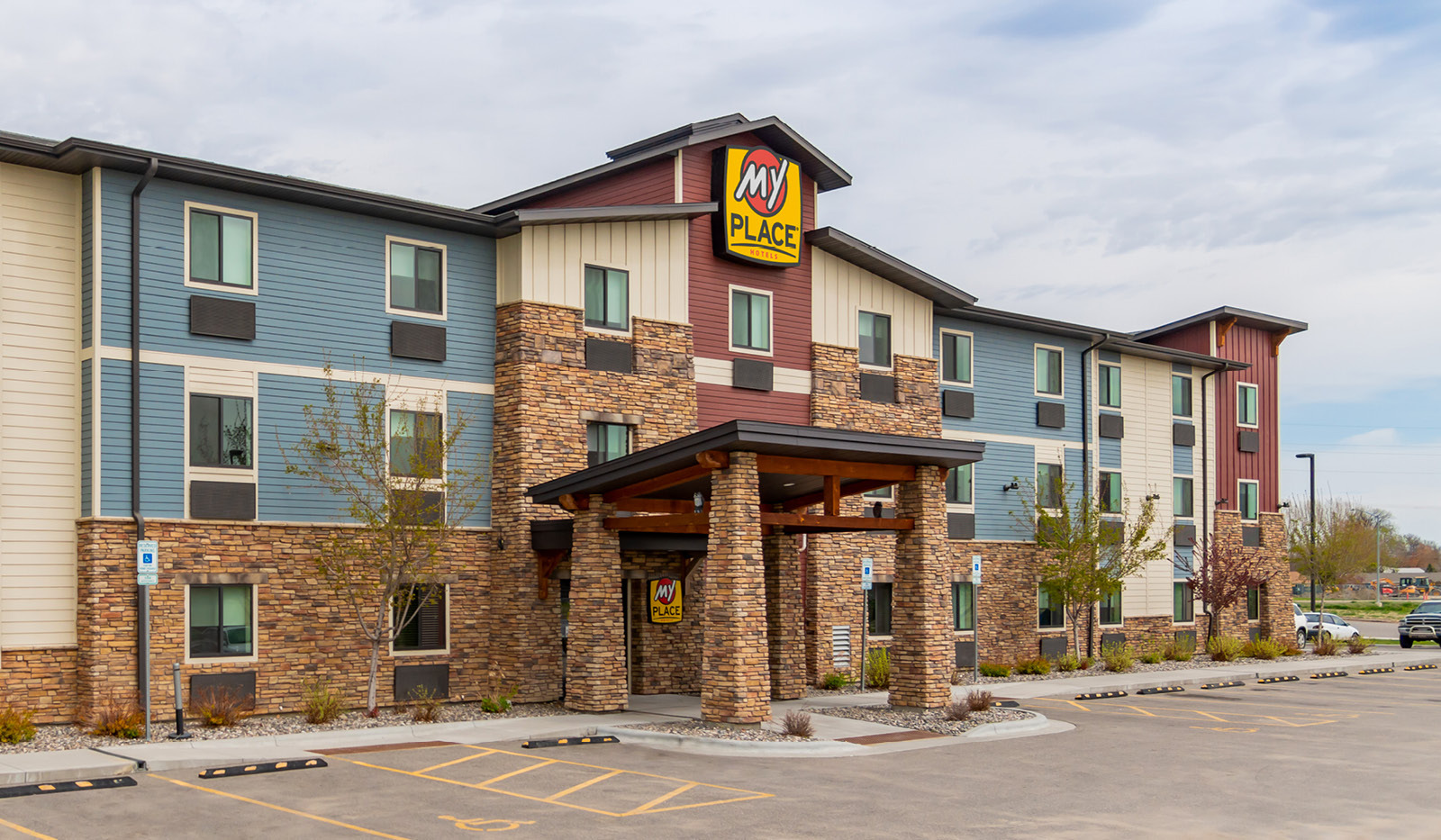 Exterior of My Place Hotel-Billings, MT under a cloudy sky.