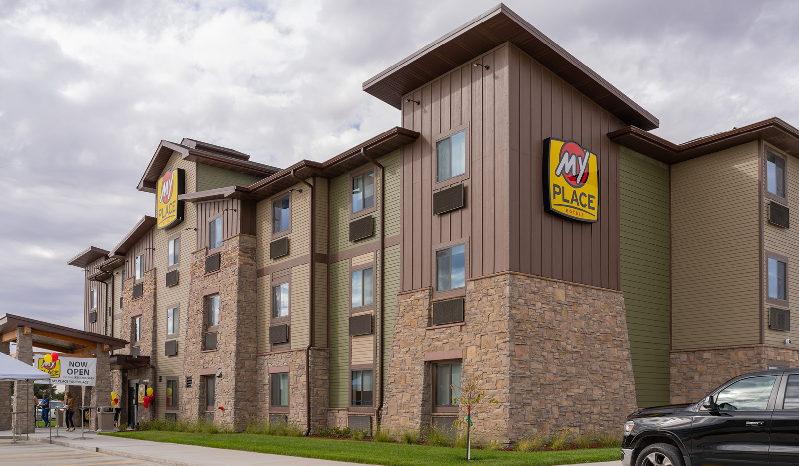 Exterior of My Place Hotel-Beatrice, NE under a cloudy sky.