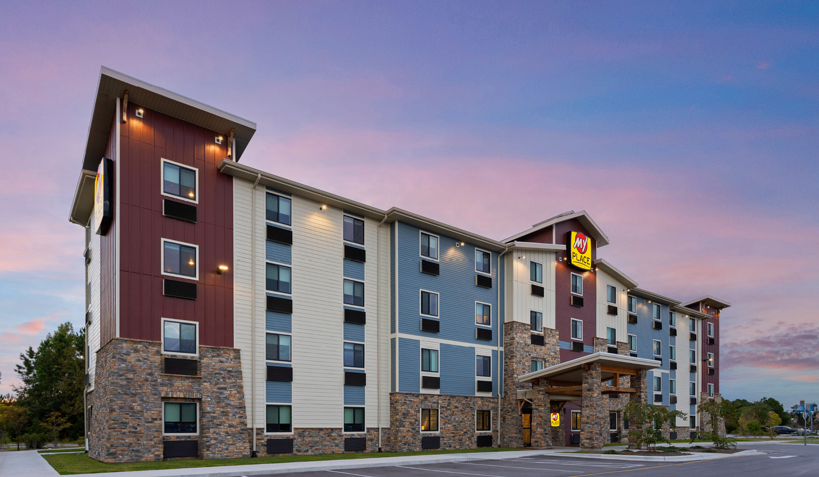 View of the property and parking lot with sunset in background.