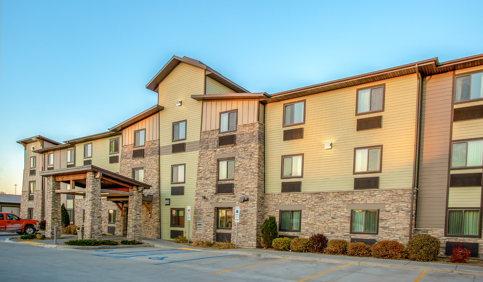 Exterior of My Place Hotel-Bismarck, ND under a clear blue sky.