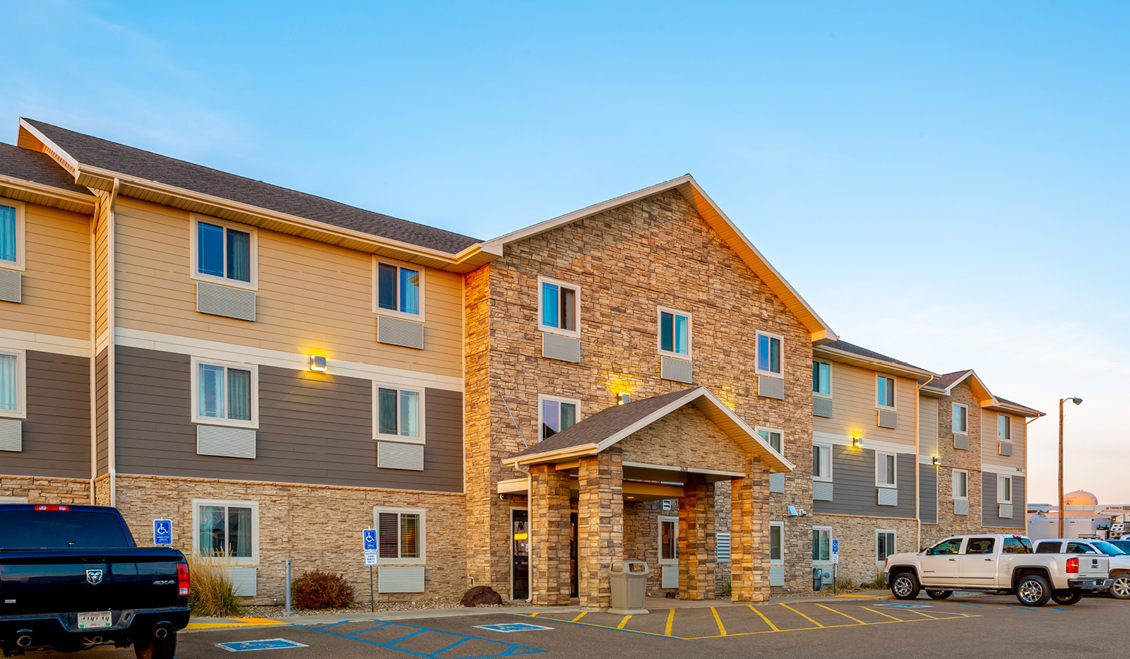 Exterior of My Place Hotel-Dickinson, ND under a clear blue sky.