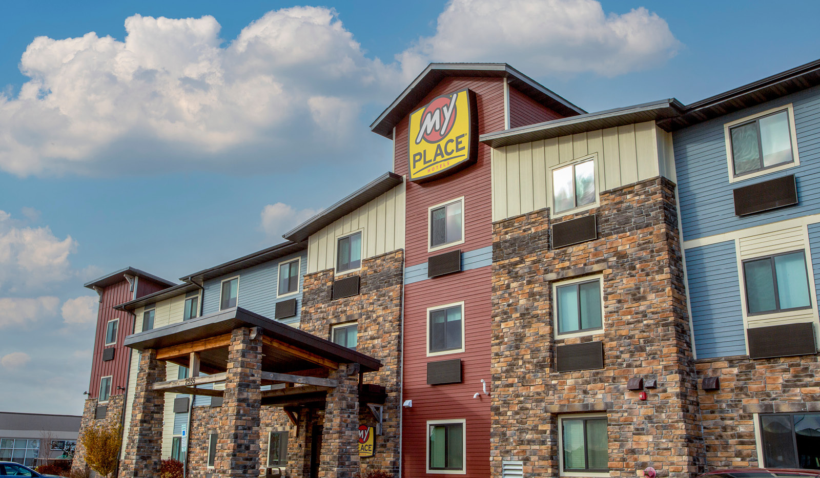 Exterior of My Place Hotel-Fargo, ND under a cloudy sky.