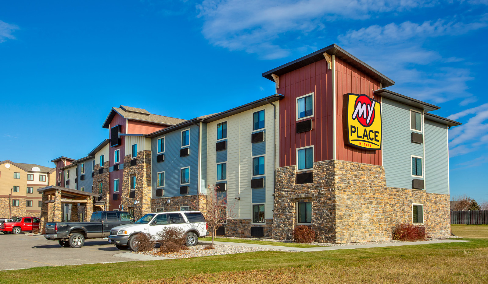 Exterior of My Place Hotel-Grand Forks, ND under a blue sky.