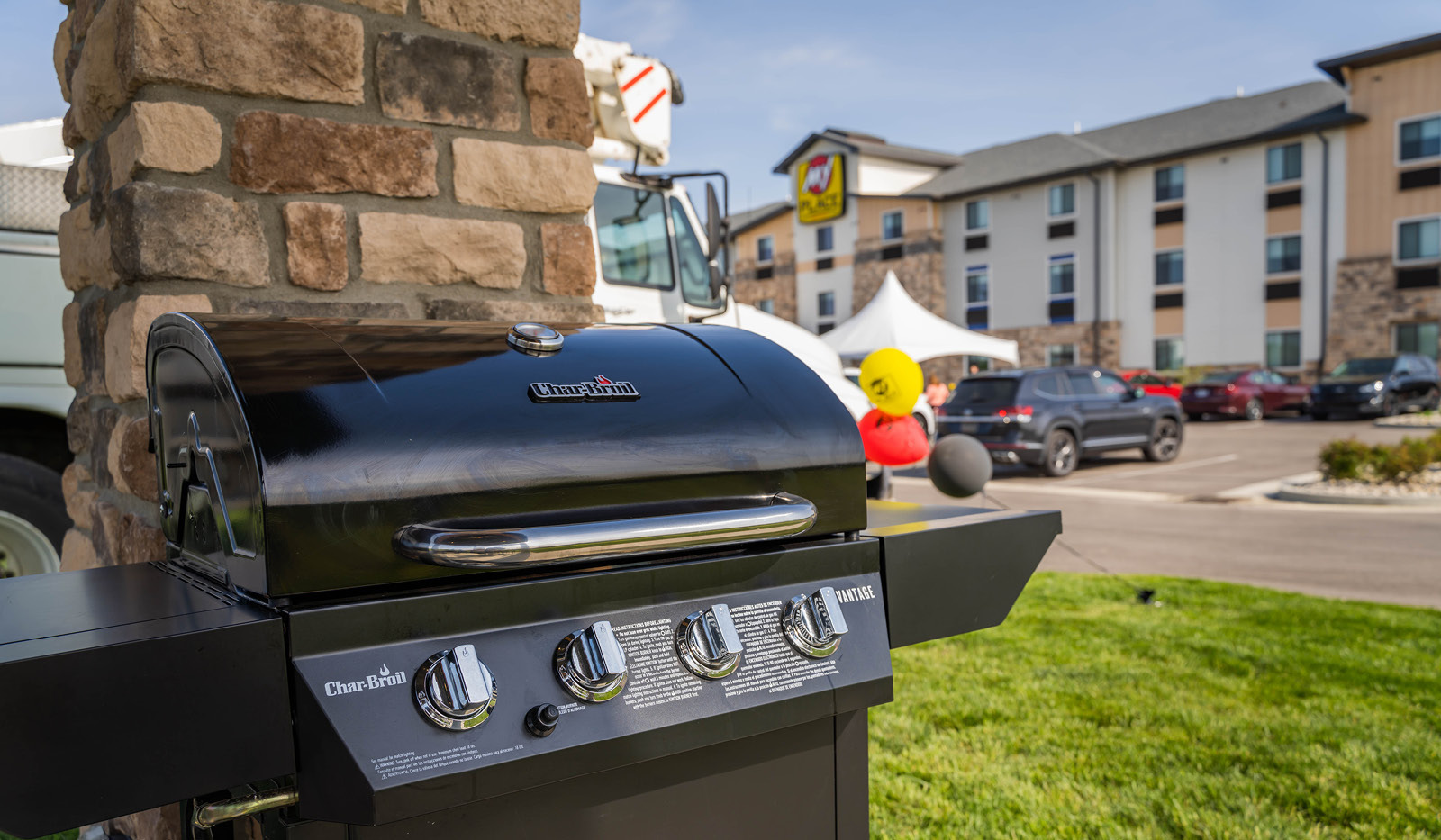 Grill under outdoor grilling pavilion with the exterior of My Place Hotel-Marion, OH in the background.