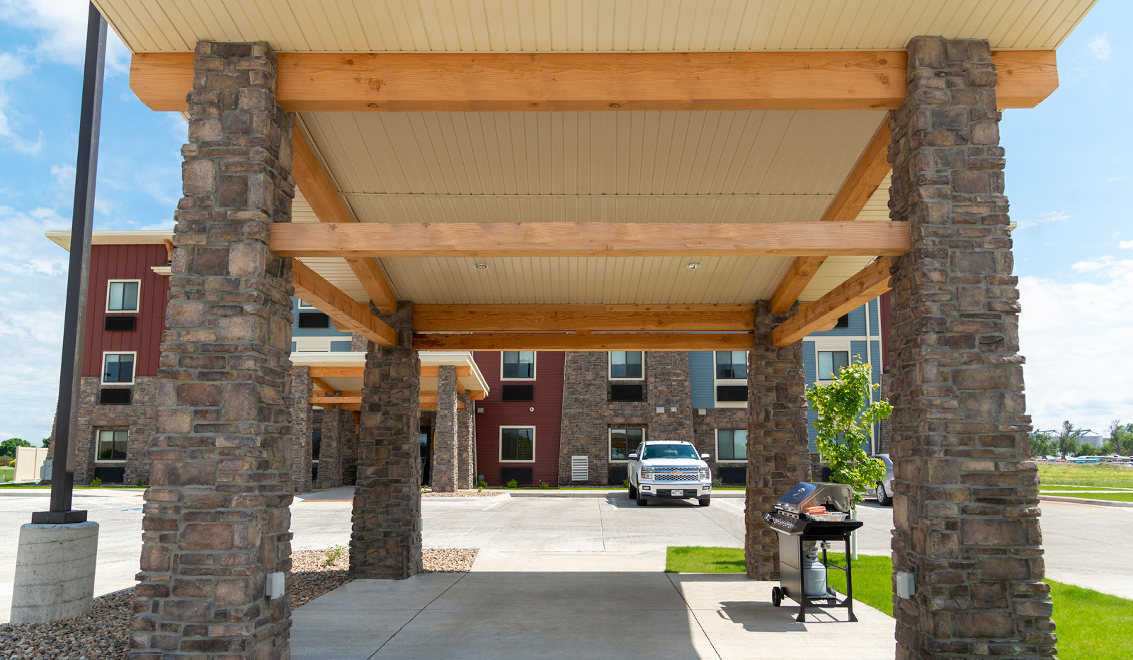 Exterior of My Place Hotel-Ft. Pierre, SD's grilling pavilion with hotel in the background.