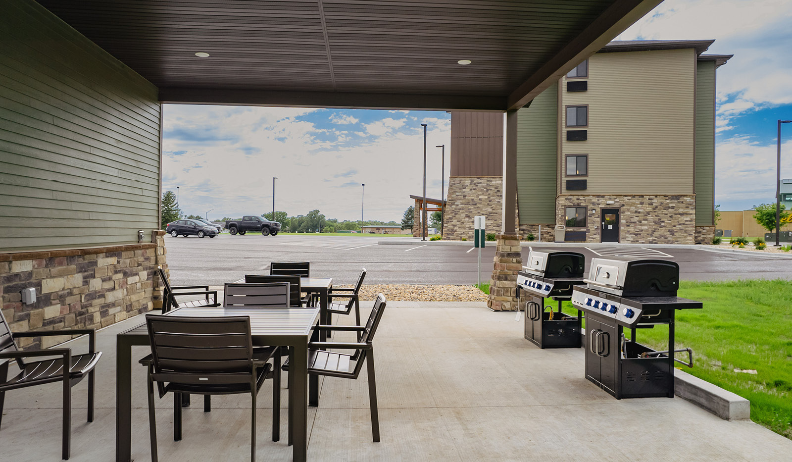 Grilling pavilion with tables, chairs, and two gas grills.