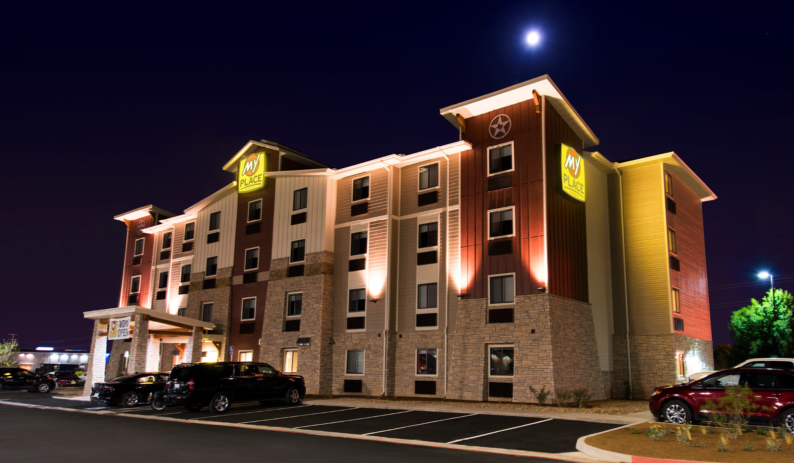 Exterior of My Place Hotel-Amarillo, TX illuminated at night.