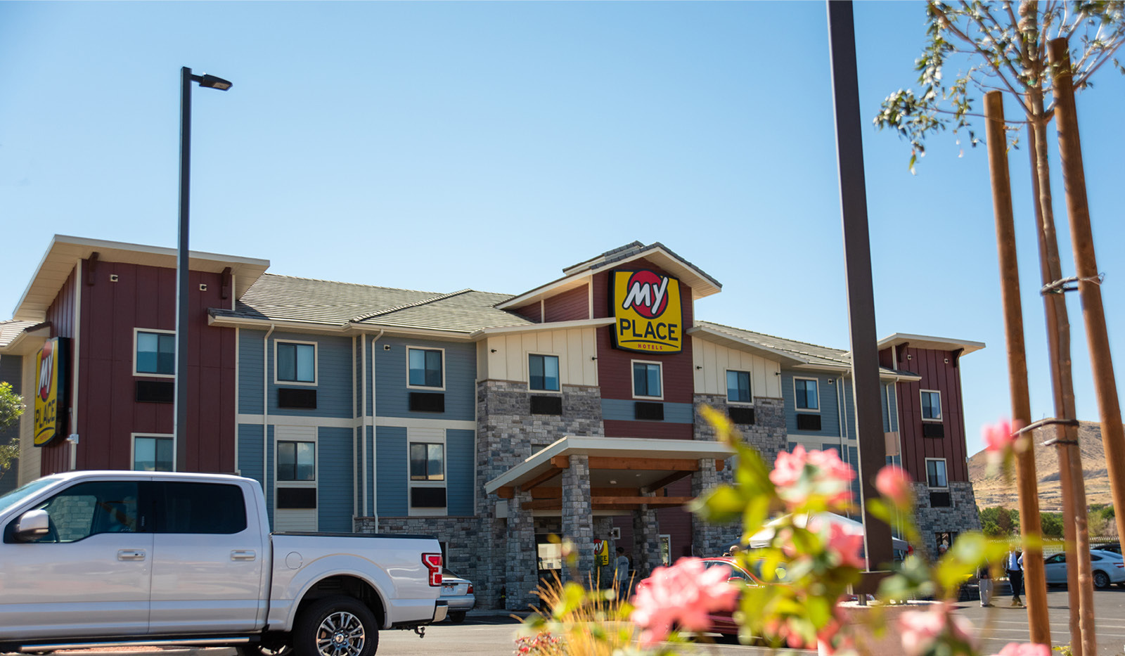 Wide exterior My Place Hotel-Hurricane, UT with flowers in the foreground.