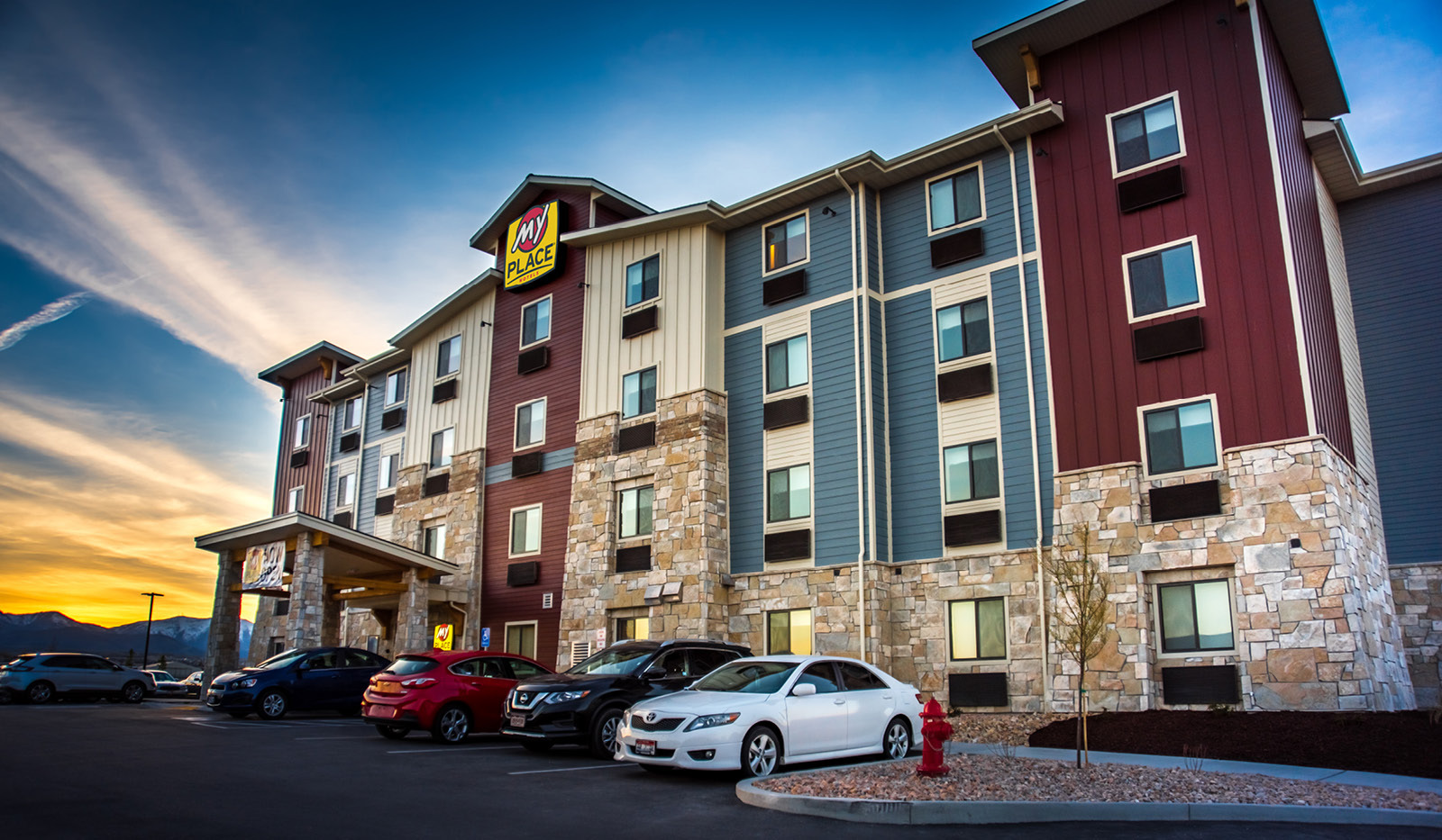 Exterior My Place Hotel-West Jordan, UT under a blue sky.