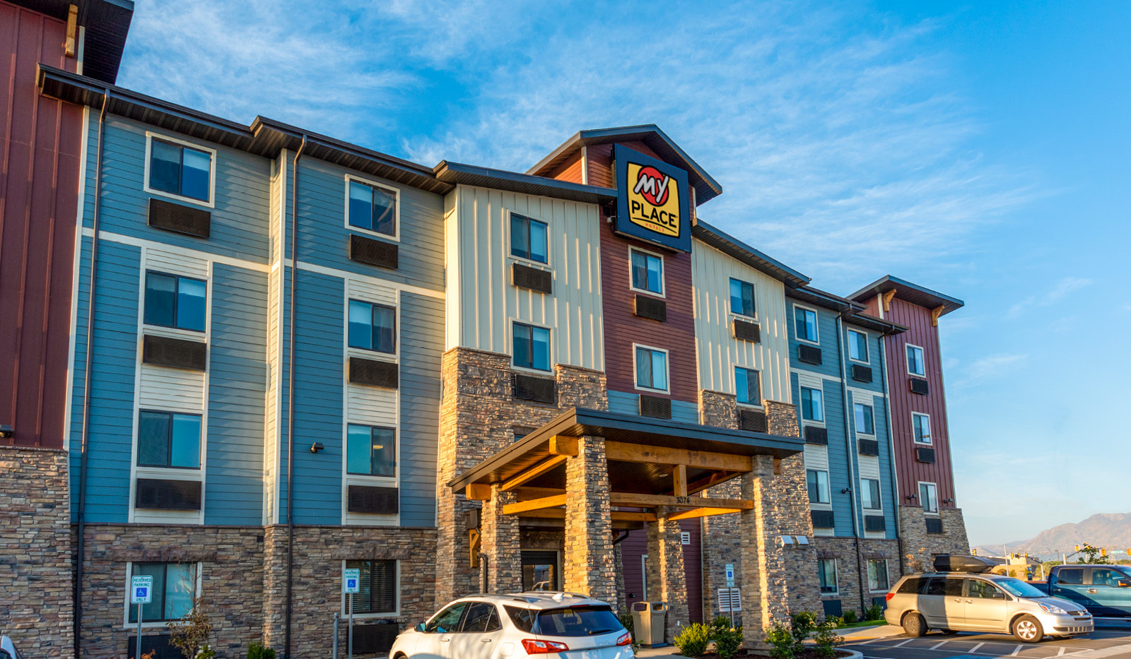 Exterior My Place Hotel-West Valley City, UT under a blue, cloudy sky.
