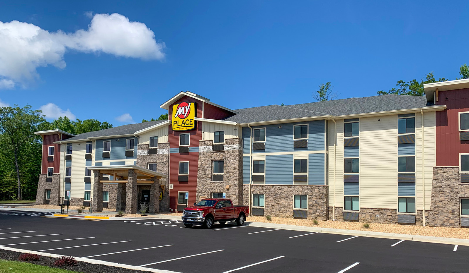 Exterior My Place Hotel-King George/Dahlgren, VA under a clear blue sky.