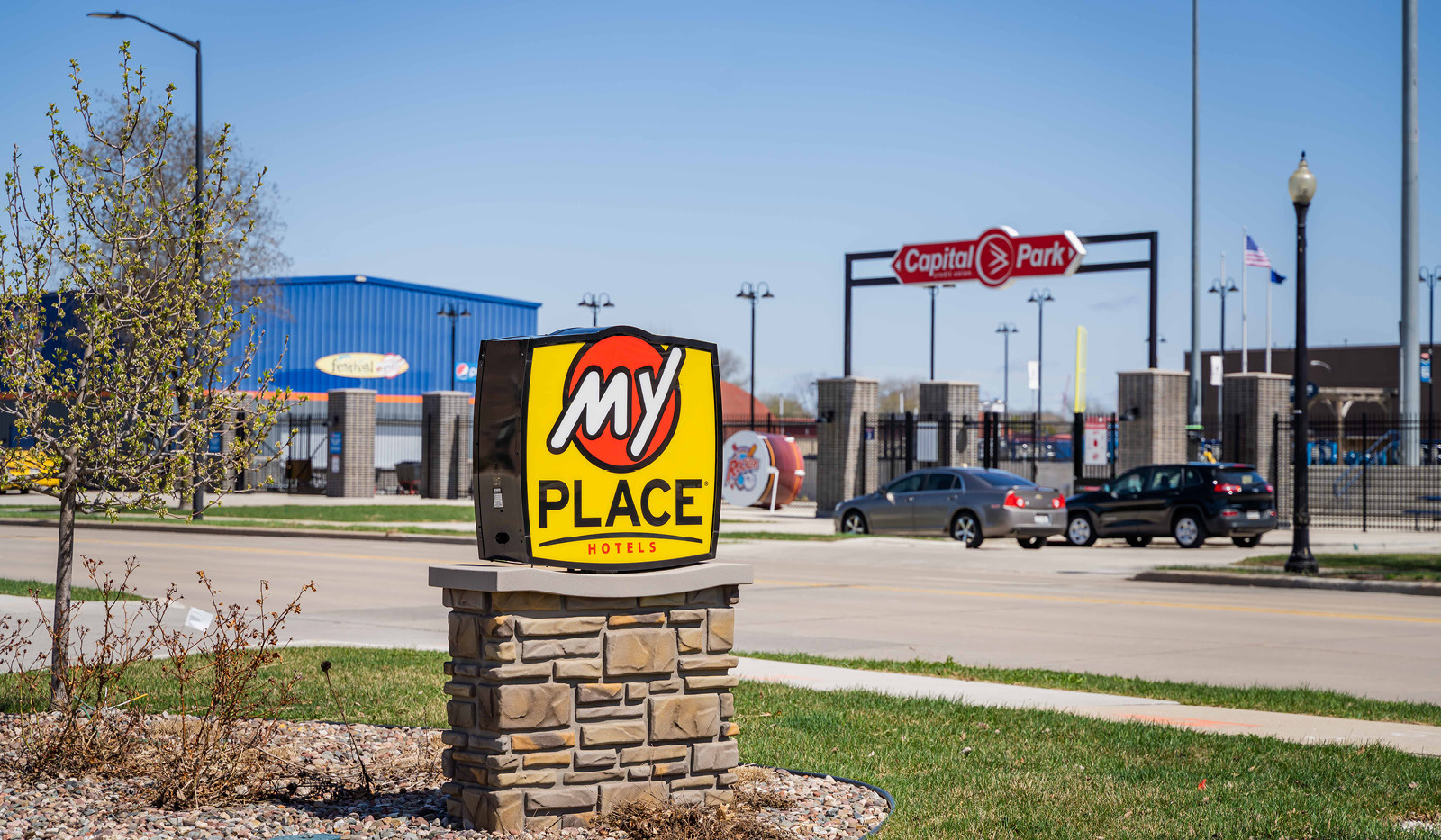 Exterior My Place Hotel-Green Bay, WI logo sign with baseball stadium in the background.