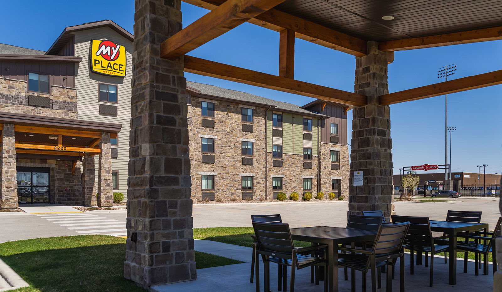 Exterior My Place Hotel-Green Bay, WI grilling pavilion with hotel in the background.