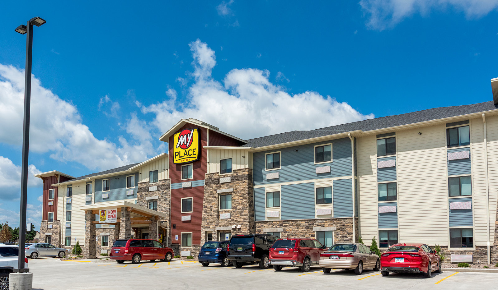 Exterior My Place Hotel-Mount Pleasant, WI under a cloudy, blue sky.