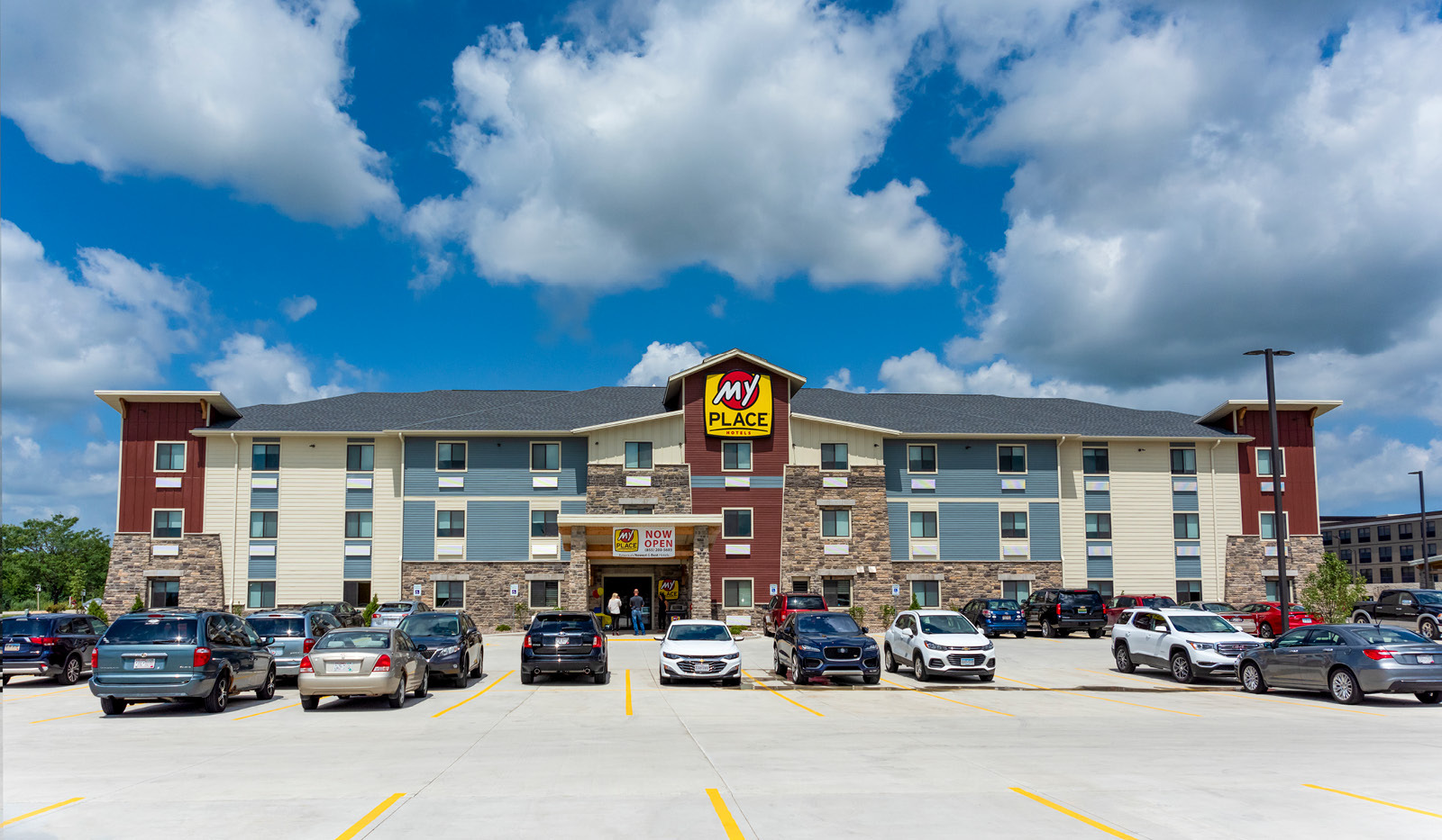 Wide exterior My Place Hotel-Mount Pleasant, WI under a partly cloudy sky.