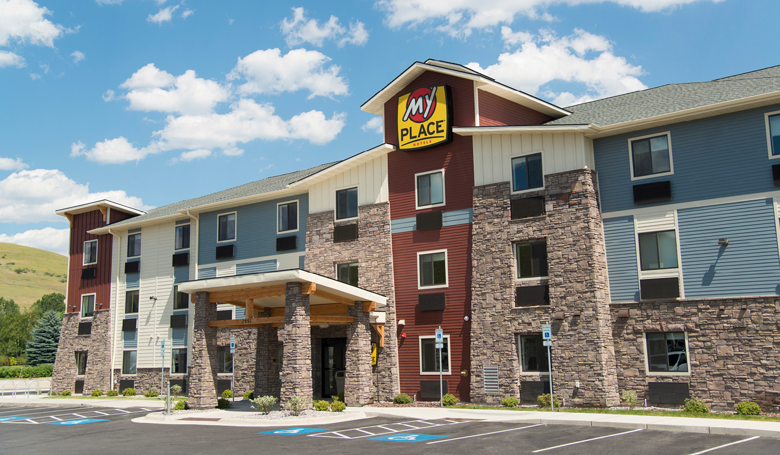 Exterior My Place Hotel-Cheyenne, WY under a partly cloudy sky.