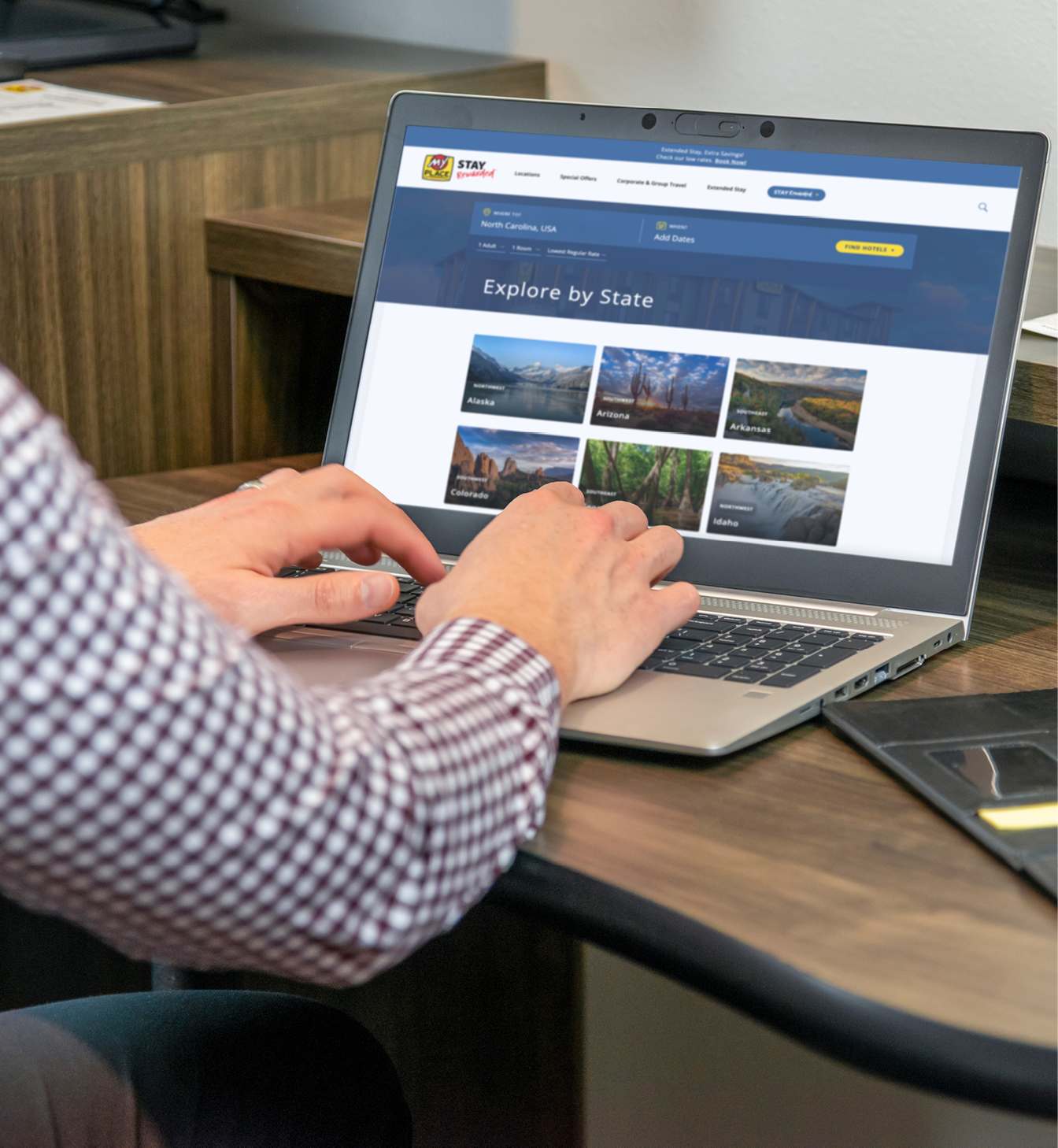 Person typing on laptop looking to book their next stay with My Place Hotels.