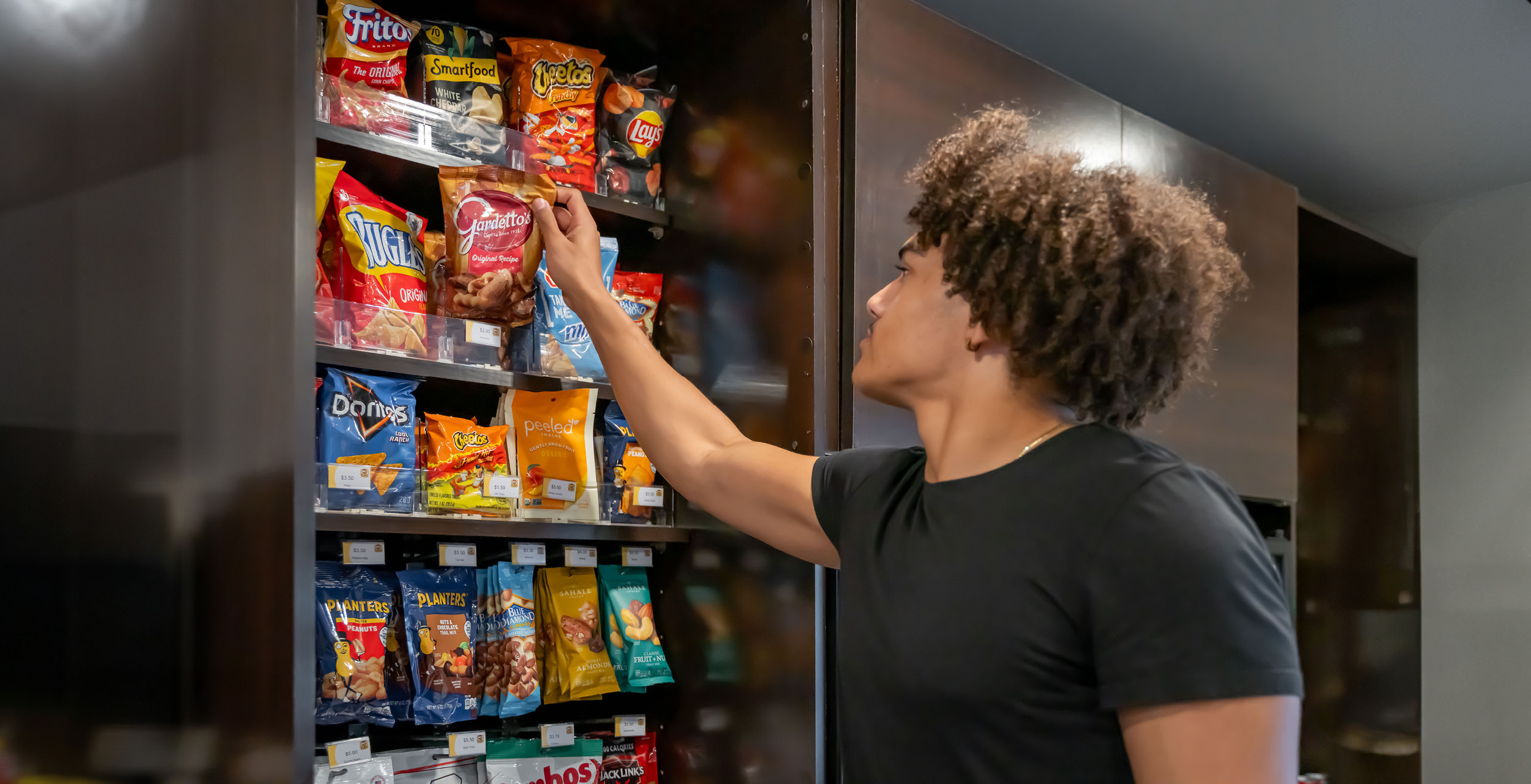 Man grabbing a snack from the grab and go store.