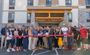 Professionals stand in front of the new Henderson hotel ready to cut the red ribbon.