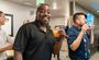 A guest poses with a drink in his hand in the new lobby of Henderson.