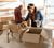 A man and women packing boxes with their golden retriever.