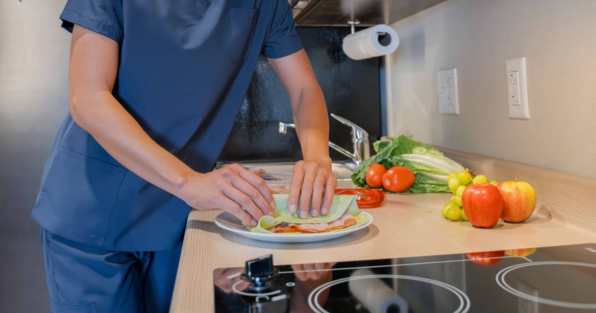 Person making lunch in a My Place Hotel kitchnette.