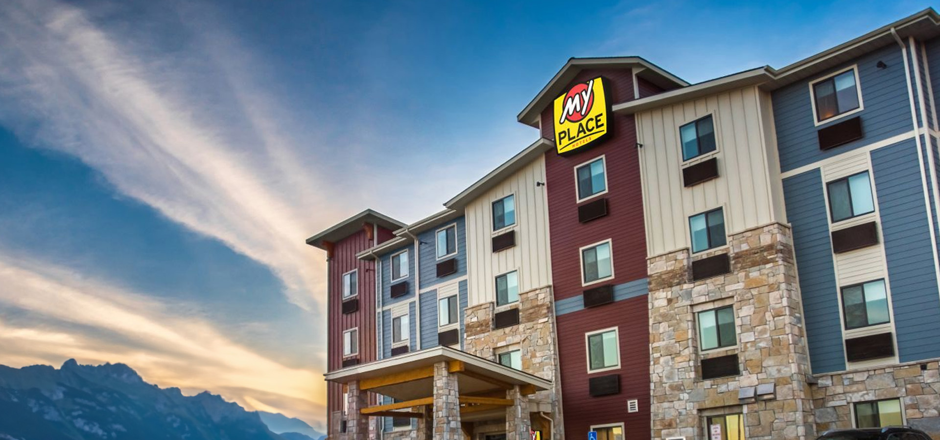My Place hotel exterior with view of mountains in the background