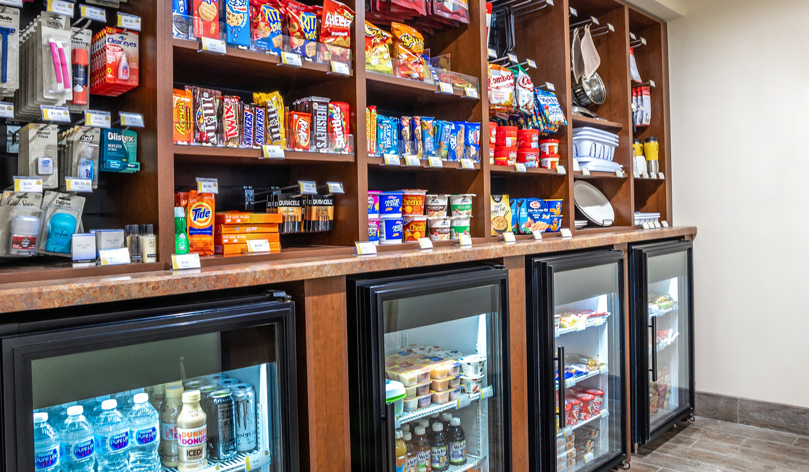 My Store with rows of snacks and toiletries above rows of coolers filled with drinks.