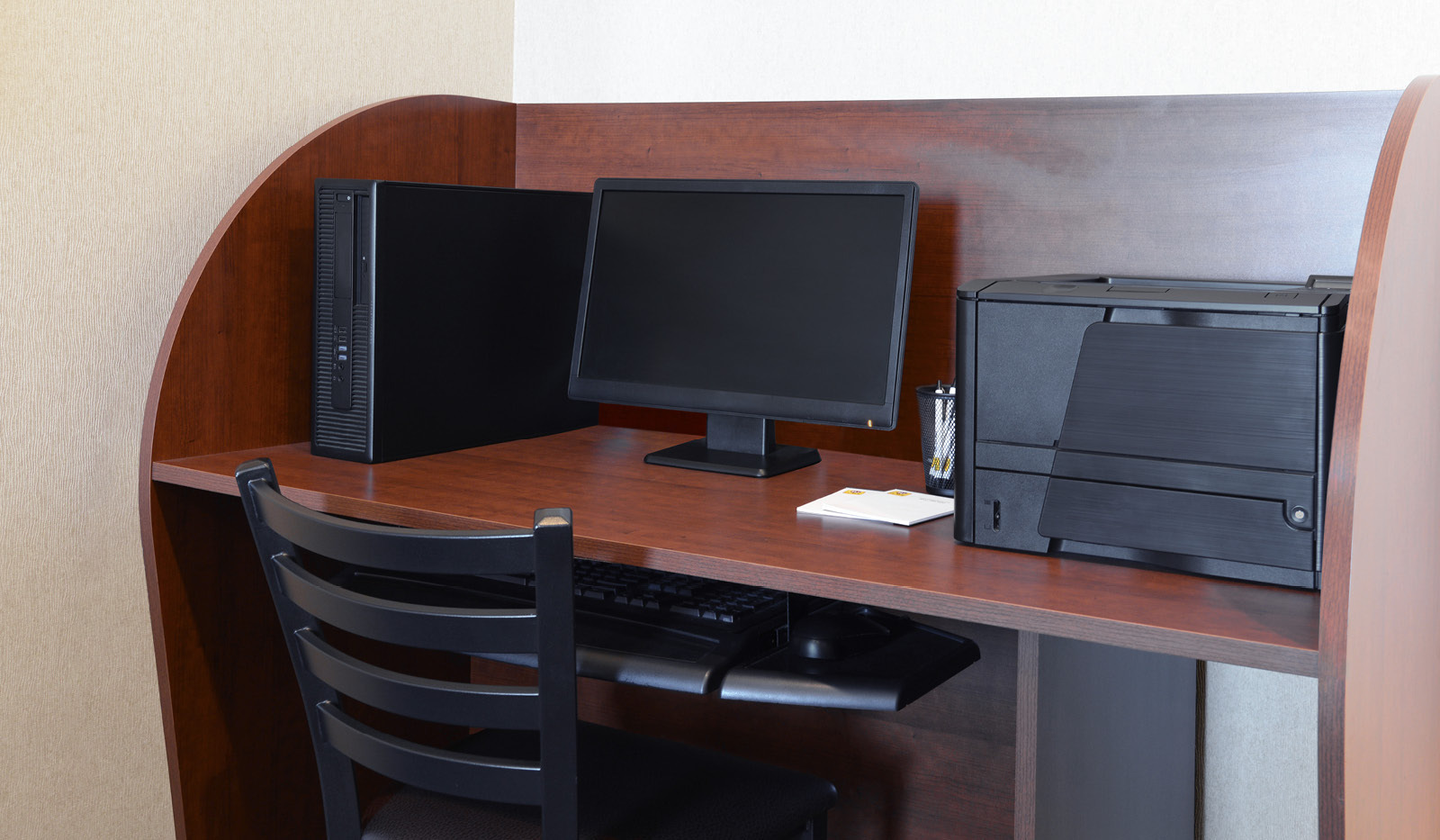 Business center with one computer, printer and chair.