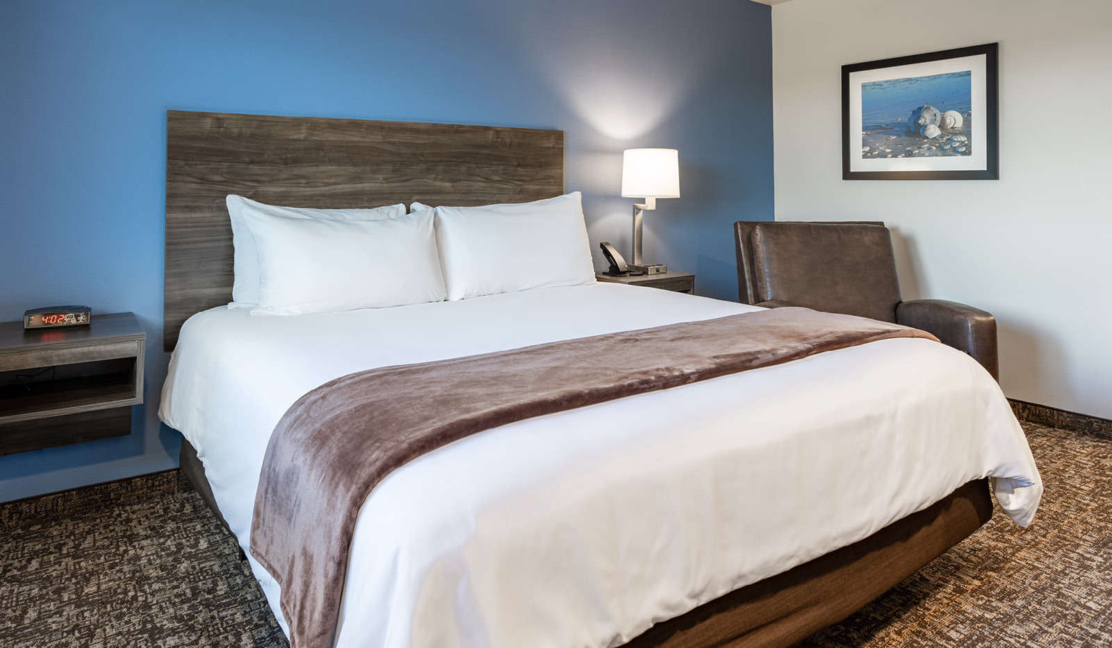 My Place Hotel room featuring one plush bed with a cozy recliner.