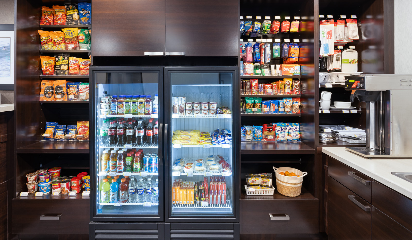 Snacks bar stocked with ready to eat snacks, packaged meals, refrigerated beverages and perishable goods.