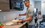 People cooking in a small kitchenette.