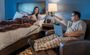 Man and woman cheers-ing their coffee mugs in a My Place room