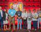 Line of people posing for awards in front of a large My Place logo.