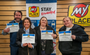 Four people showing their My Place University diploma.